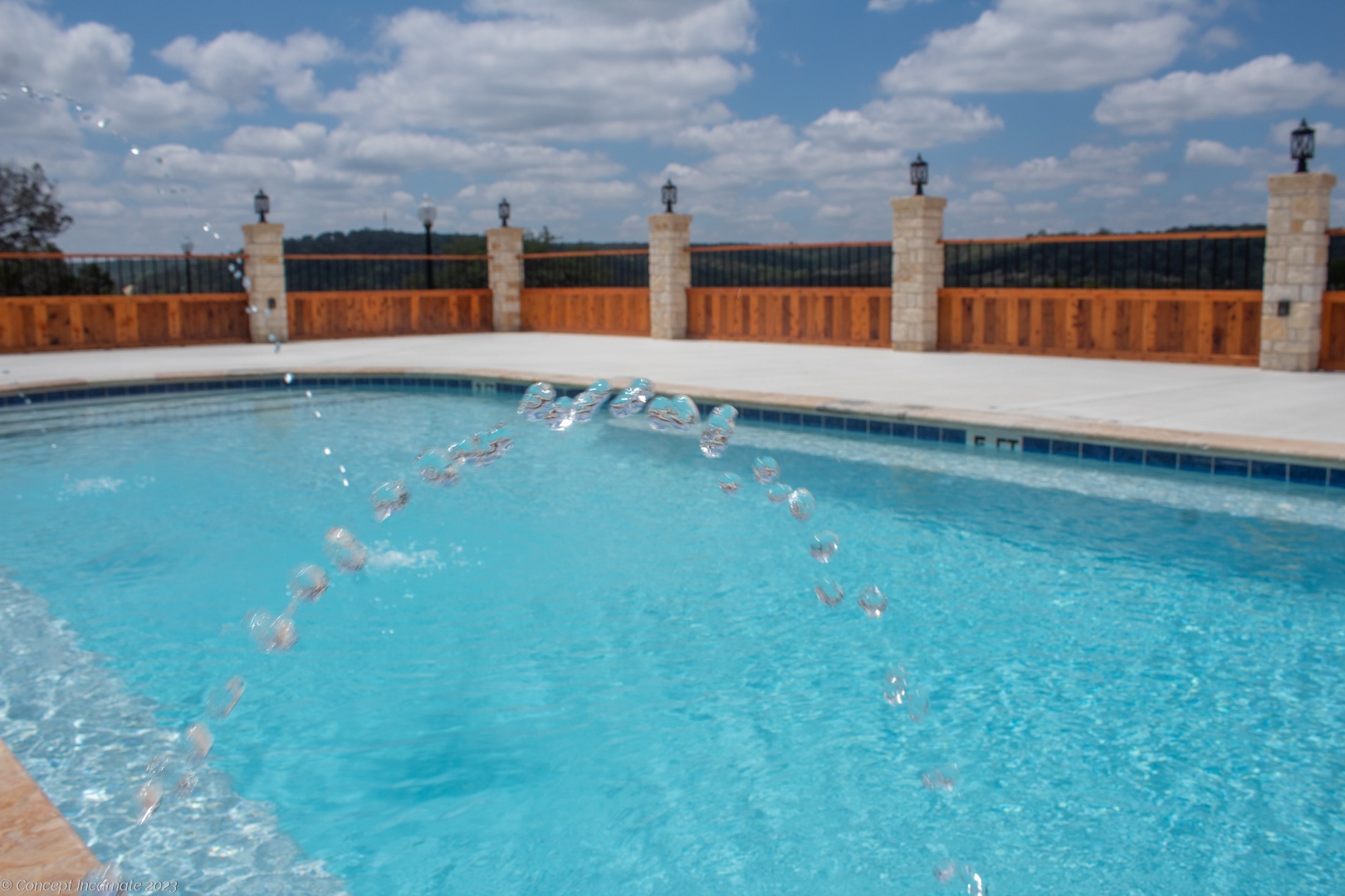 Pool with water spout feature Pool with water spout feature